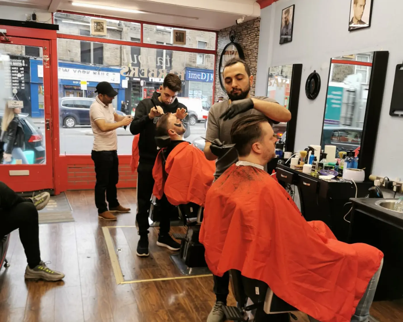 Three barbers cutting hair at Istanbul Barbers of Tollcross