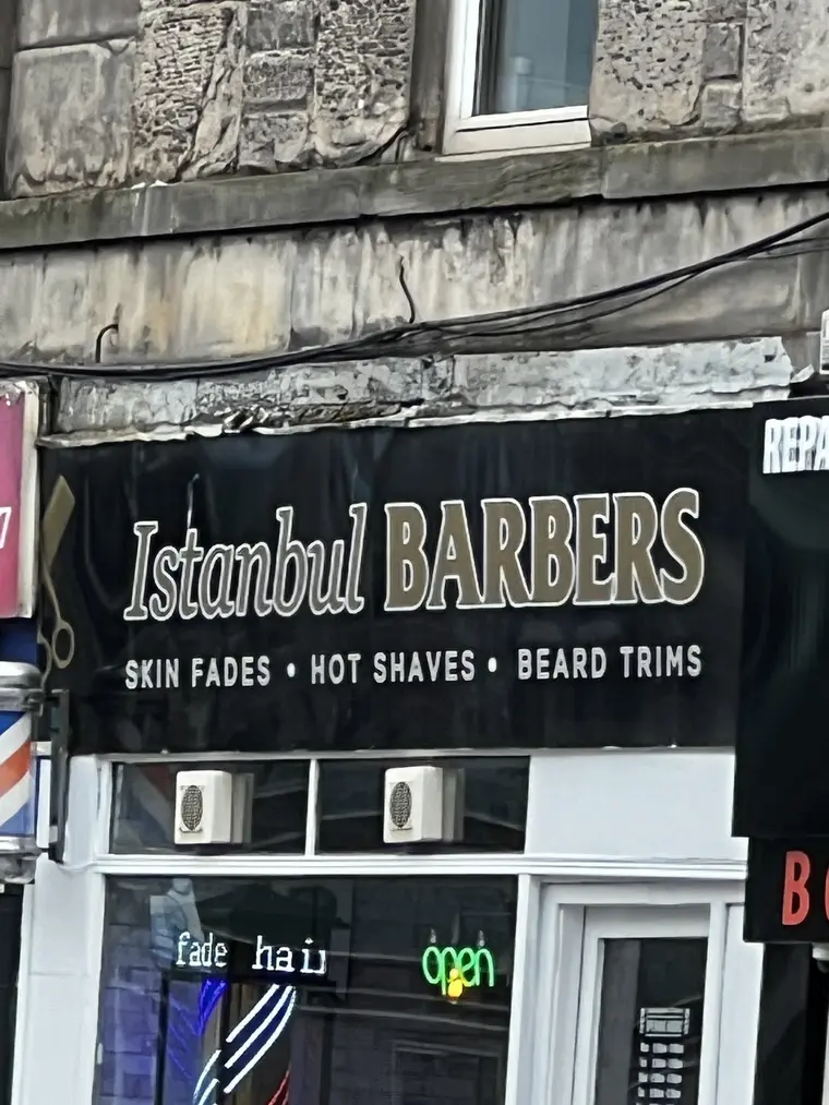 Istanbul Barbers black and gold shopfront sign on Home Street